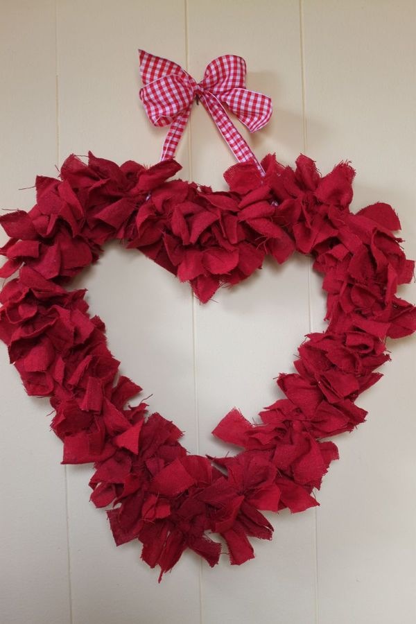 Red shop towel heart shaped wreath made with a hanger and garage rags