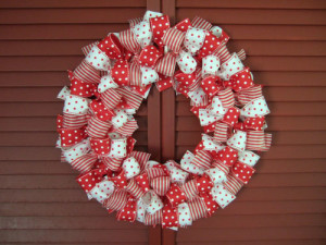 Easy Valentine's wreath made with various patterns of red and white wired ribbon tied into bows around a wire circle