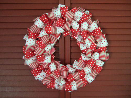 Easy Valentine's wreath made with various patterns of red and white wired ribbon tied into bows around a wire circle